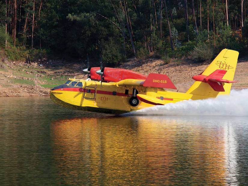 Canadair DHC-515 scooping water from a lake, side view