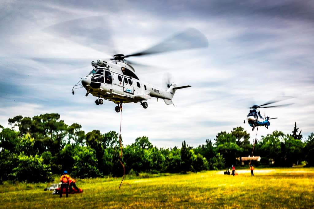 Water-bombing helicopter manoeuvring at low altitude